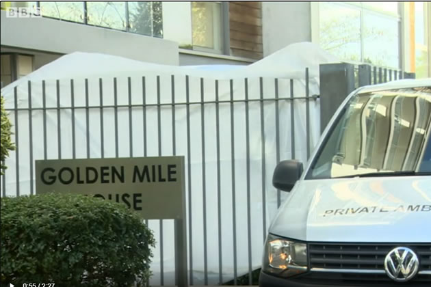 An ambulance and forensics tent outside the apartment