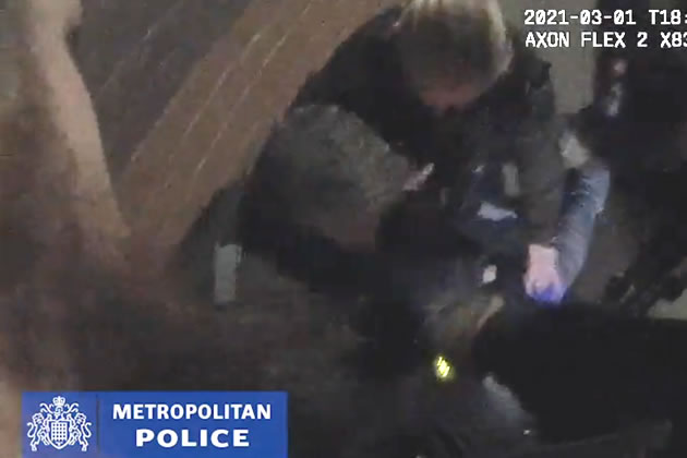 Police detaining David Longhor after he was found with two machine guns